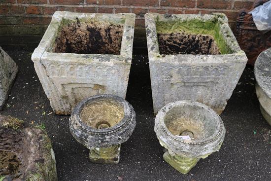 A pair of terracotta leaf moulded vases and a further pair in reconstituted stone (4)